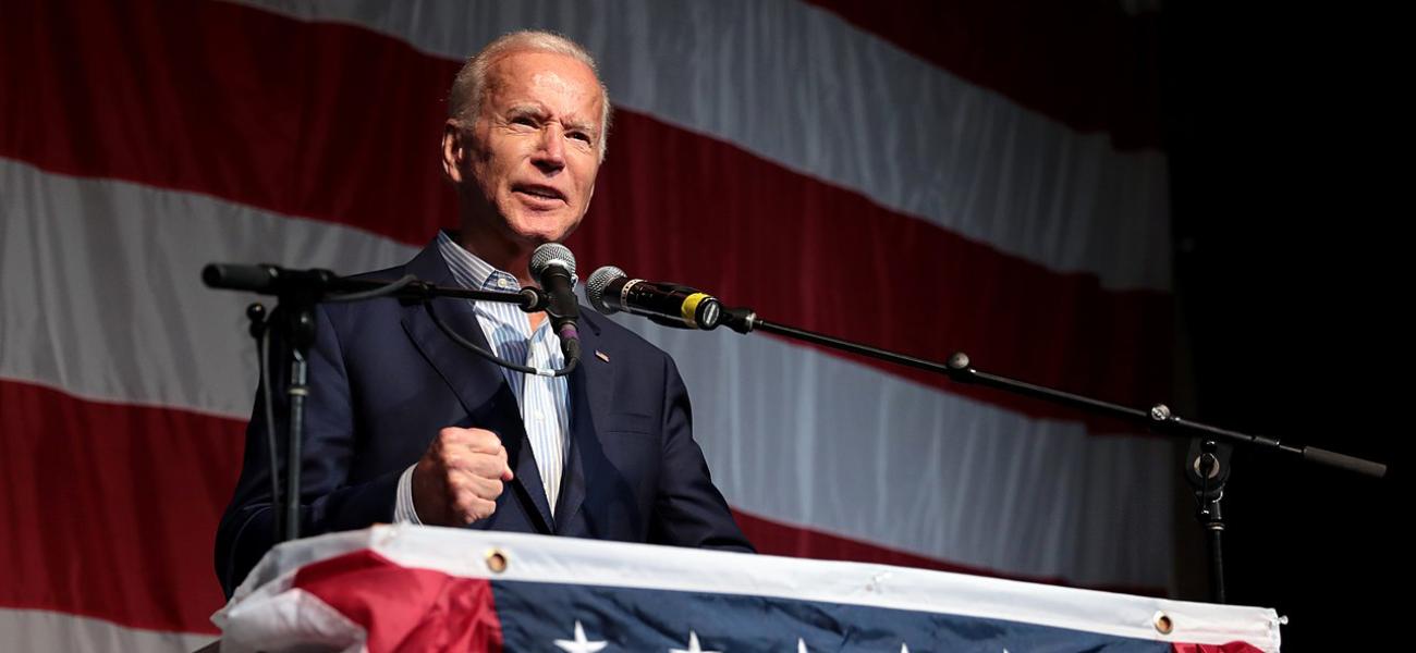 Joe Biden speaking at a podium.