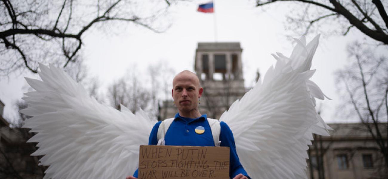A man dressed as a peace dove stands in front of the Russian Embassy during protests marking the first anniversary of Russia's full-scale invasion of Ukraine, in Berlin, Germany, Friday, Feb. 24, 2023. (AP Photo/Markus Schreiber)