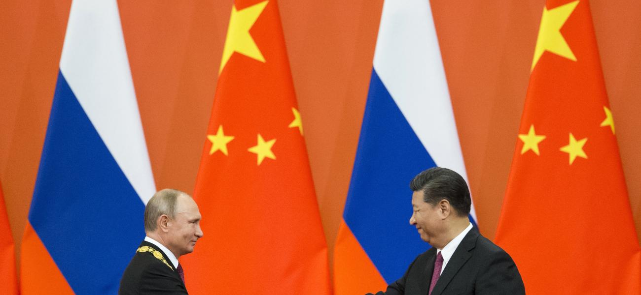 Chinese President Xi Jinping, right, and Russian President Vladimir Putin shake hands during an awarding ceremony at the Great Hall of the People in Beijing, China.