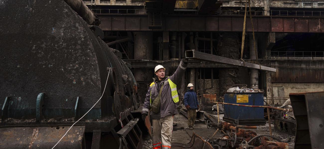A worker lowers a metal bar to the ground using a crane during repairs to DTEK's power plant after a recent Russian missile attack in Ukraine, Nov. 28, 2024.