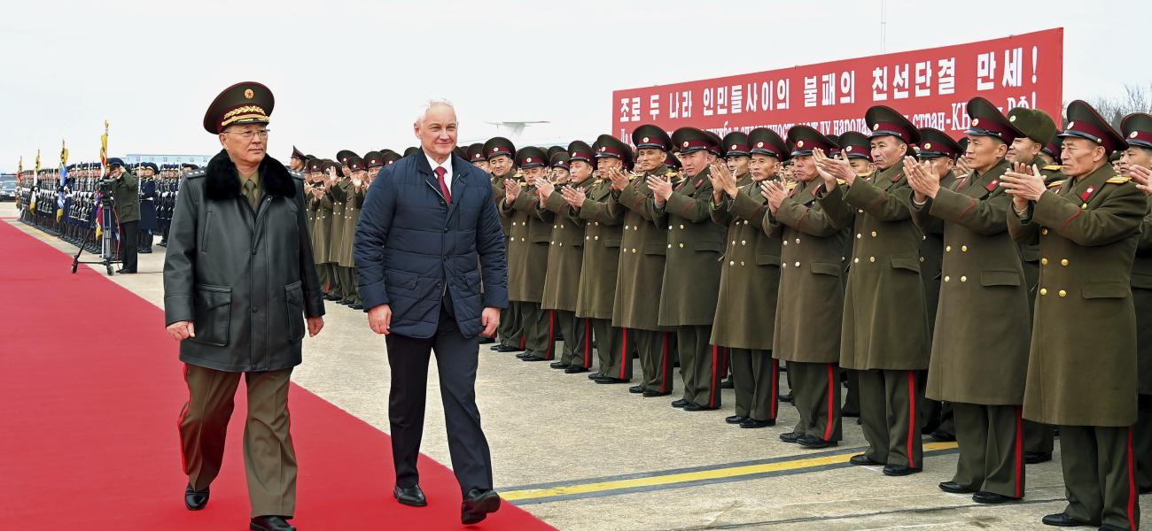 Defense Minister No Kwang Chol, left, walks with Russia's Defense Minister Andrei Belousov at Pyongyang International Airport.