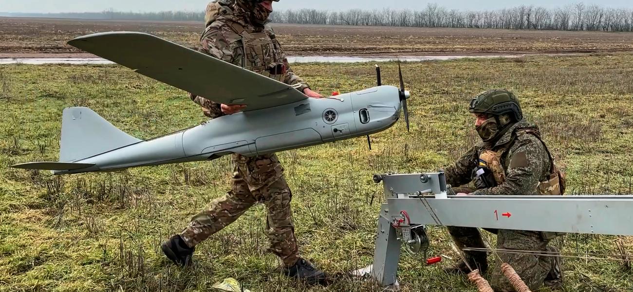 In this image made from video provided by Russian Defense Ministry Press Service on Sunday, Feb. 15, 2026, shows Russian servicemen preparing to launch an Orlan-10 reconnaissance drone for an action in an undisclosed location in Ukraine. (Russian Defense Ministry Press Service via AP)