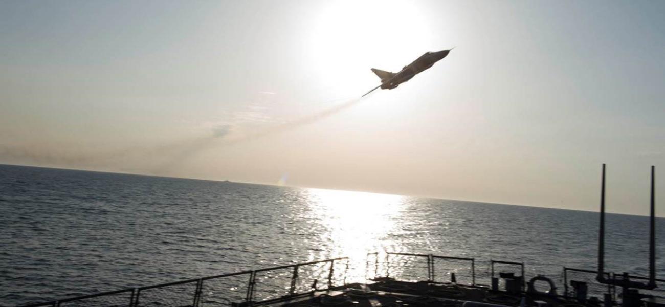 A Russian Sukhoi Su-24 attack aircraft makes a low altitude pass by USS Donald Cook