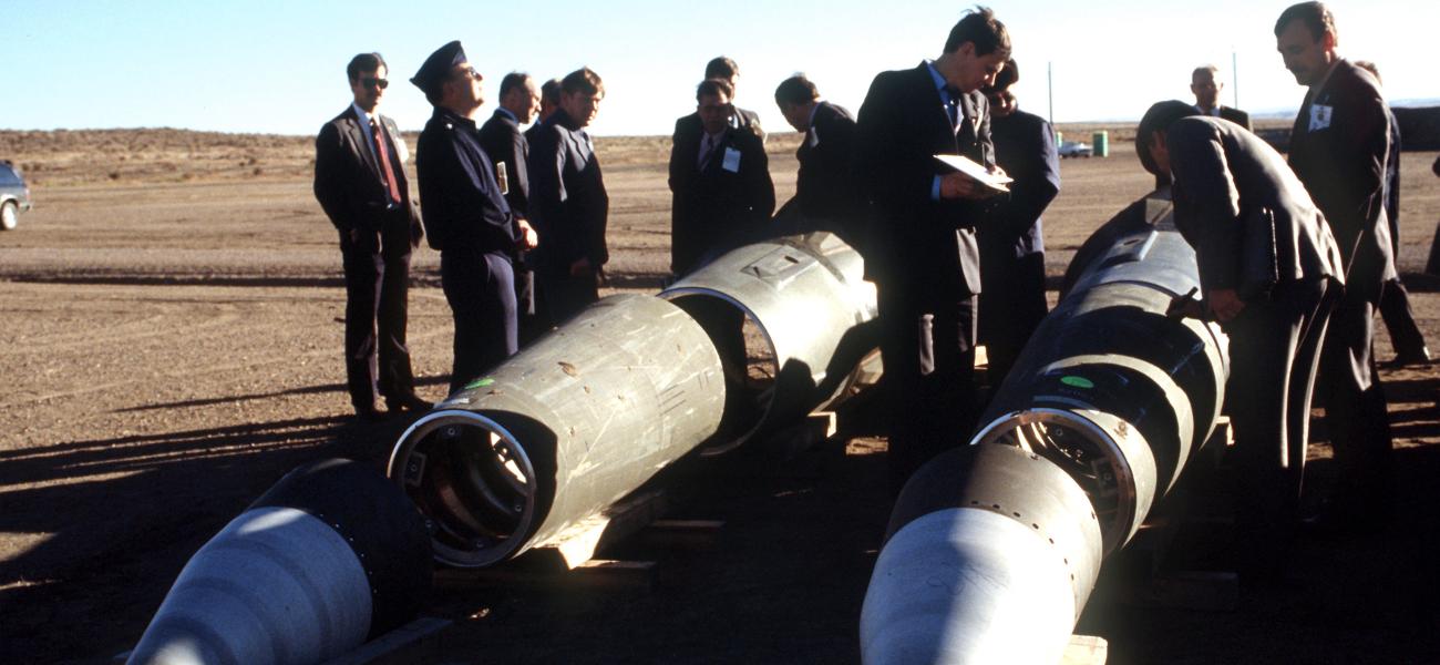 Soviet inspectors and their American escorts standing among dismantled Pershing II missiles in Colorado as other missile components are destroyed nearby under the INF Treaty, January 1989.
