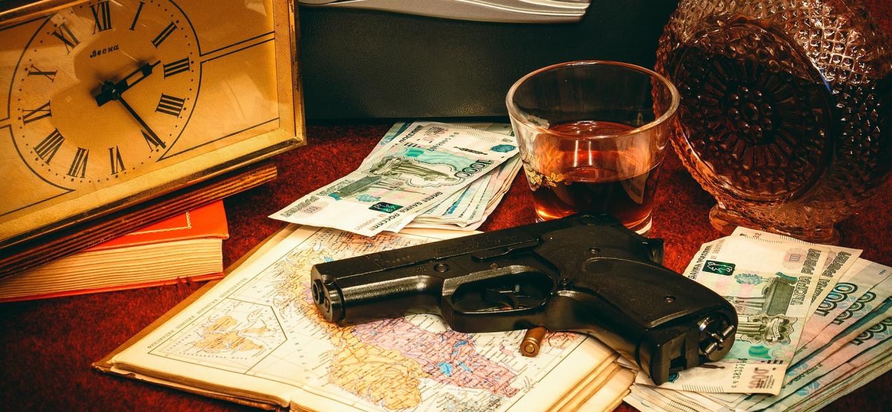 Gun and bullet on a map next to ruble bills.