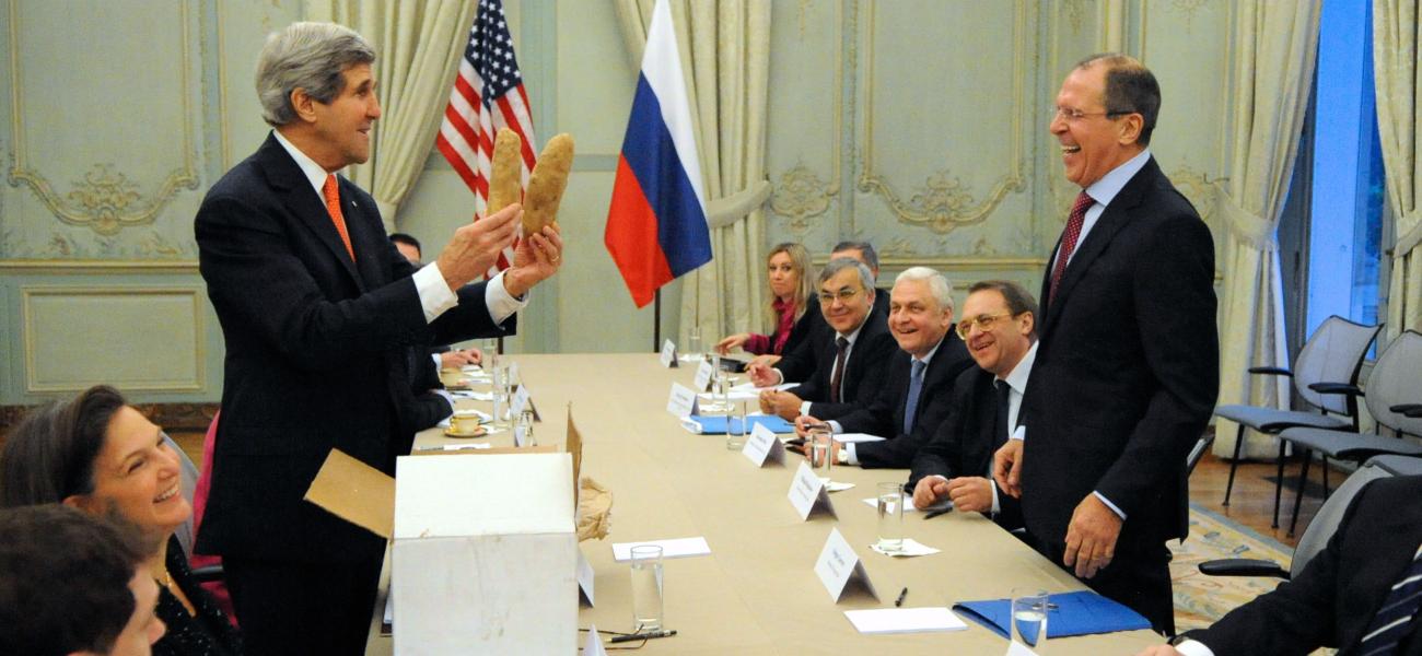 U.S. Secretary of State John Kerry shows Russian Foreign Minister Sergey Lavrov a pair of giant Idaho potatoes -- once a subject of discussion between them -- before a bilateral meeting with their respective staffs in Paris, France, on January 13, 2014.