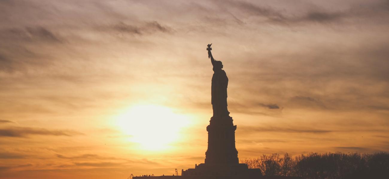The Statue of Liberty in New York silhouetted against the sky.