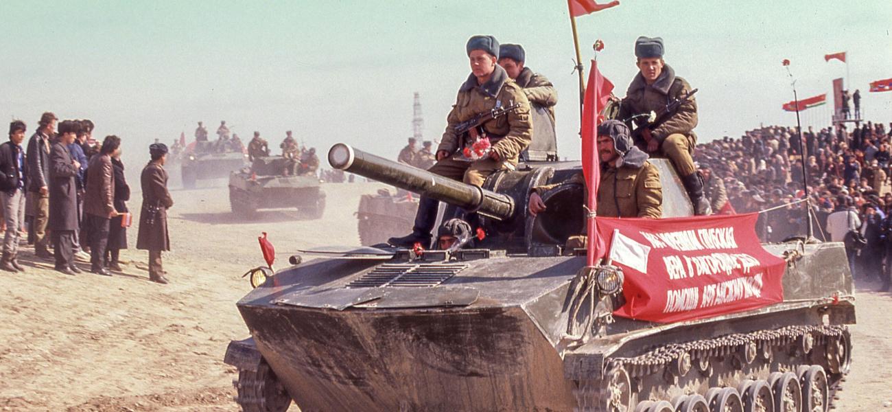 A light tank with Soviet troops, the last Soviet soldiers to leave Afghanistan, ride to a ceremony in the Uzbek Soviet Socialist Republic.   (Arnold Drapkin/ZUMAPRESS.com)
