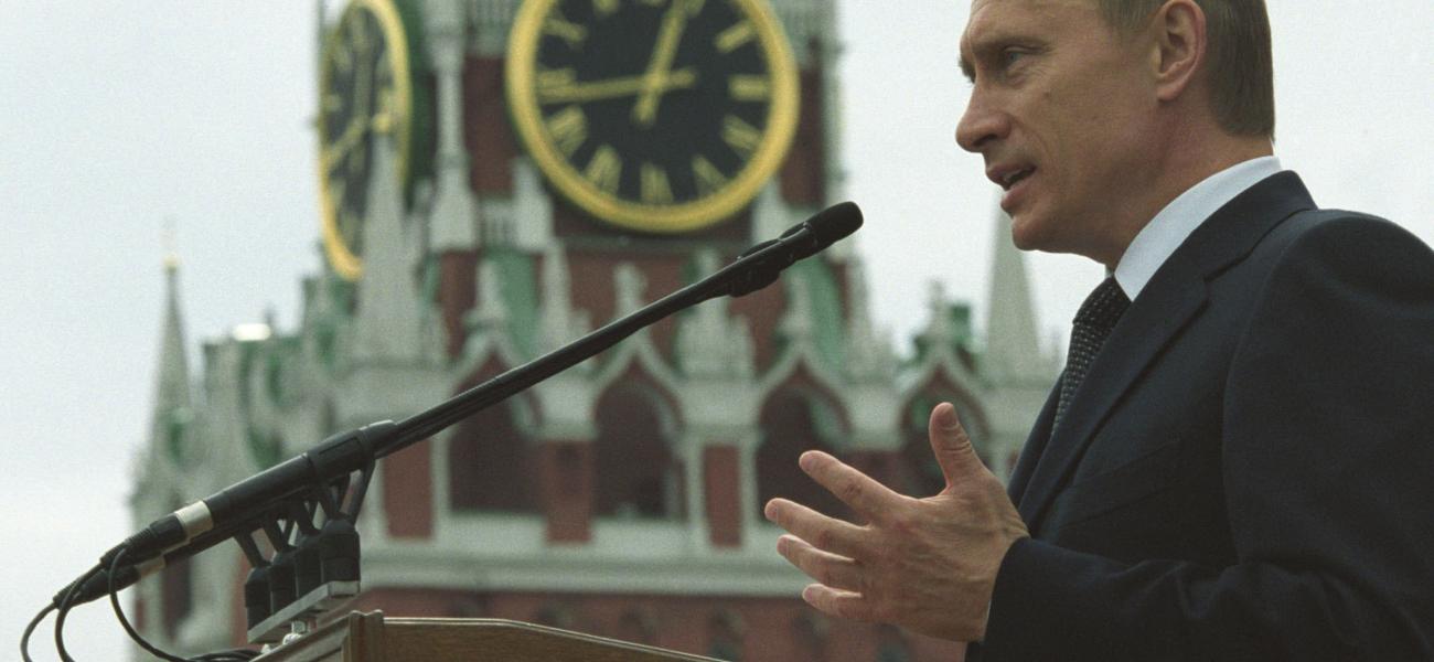 Russian President Vladimir Putin speaking outside the Kremlin with the Kremlin clock behind him.  