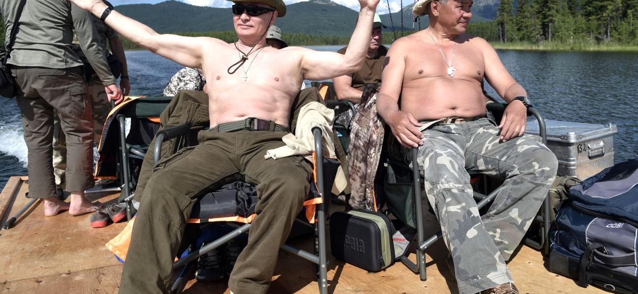Russian President Vladimir Putin with Defense Minister Sergei Shoigu relaxing shirtless on a boat in Siberia.