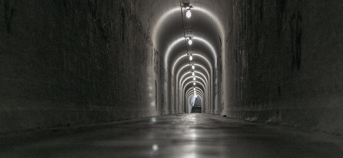 Dark tunnel with lanterns.