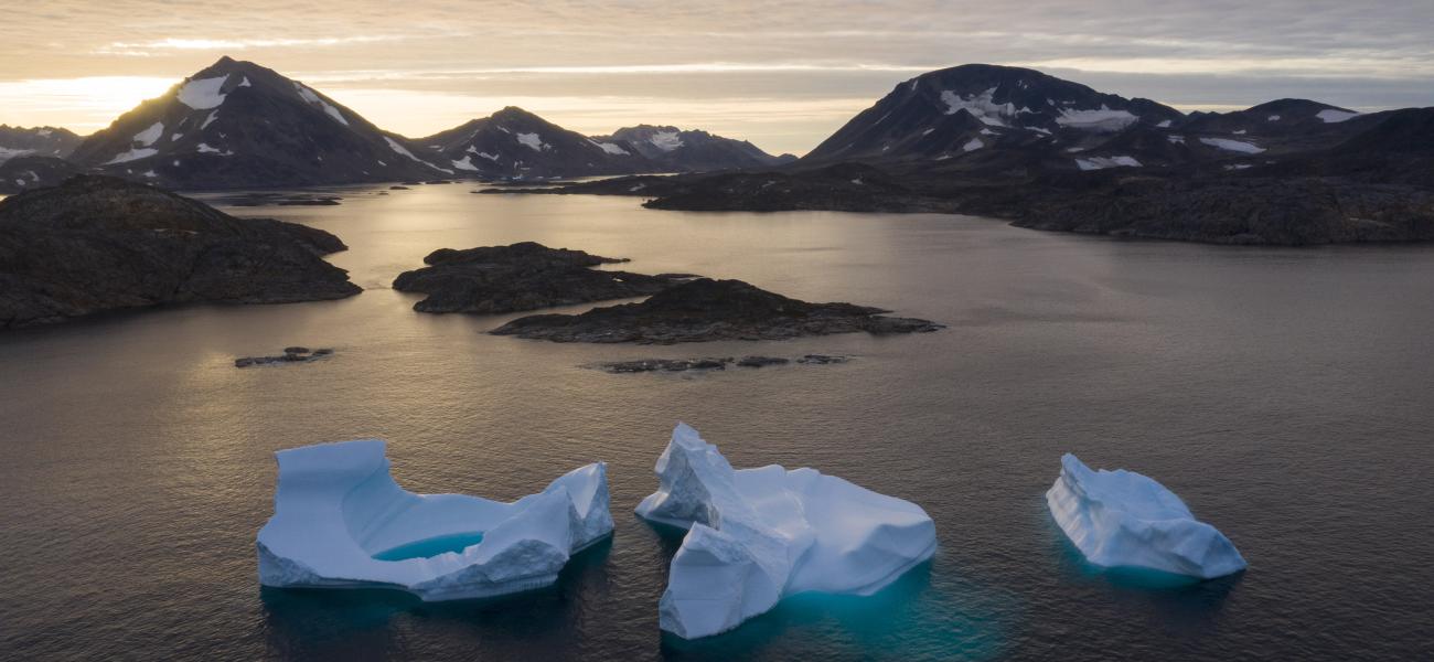 Large Icebergs float away as the sun rises near Kulusuk, Greenland, Aug. 16, 2019.