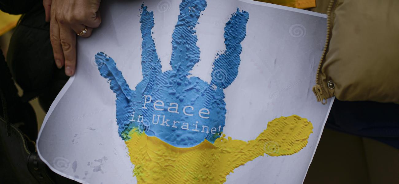 Ukrainian women holds a banner for peace in Ukraine at a protest at Plaza del Castillo square during the 2th anniversary of Russia's invasion of Ukraine, in Pamplona, northern Spain, Saturday, Feb. 24, 2024. (AP Photo/Alvaro Barrientos)