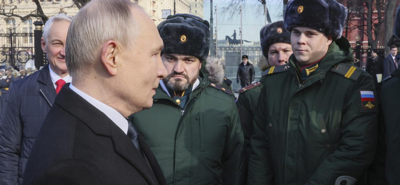Russian President Vladimir Putin speaks with servicemen during a wreath-laying ceremony at the Tomb of the Unknown Soldier, near the Kremlin Wall during the national celebrations of the "Defender of the Fatherland Day" in Moscow, Russia, Sunday, Feb. 23, 2025. (Mikhail Metzel, Sputnik, Kremlin Pool Photo via AP)