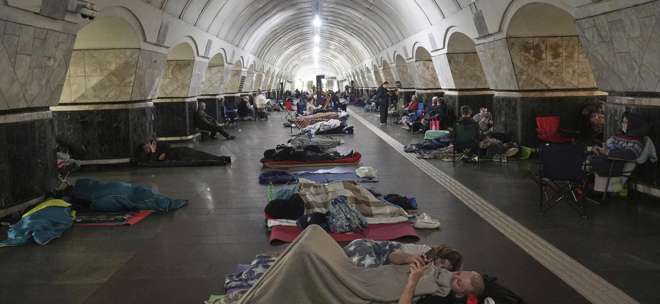 People rest in a metro station, being used as a bomb shelter, during a Russian attack in Kyiv, Ukraine, early Thursday, July 10, 2025. (AP Photo/Efrem Lukatsky)